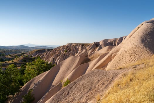 beautiful sunset landscape with typical geological soft rock formations pattern in Cappadocia plateau Turkey