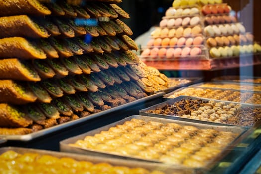rows of Turkish delight sweets desserts with dried fruits arranged in a pyramid shape and lined up in the store window
