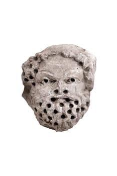 antique male demon stone statue head with open mouth and holes in hair and beard isolated on white background