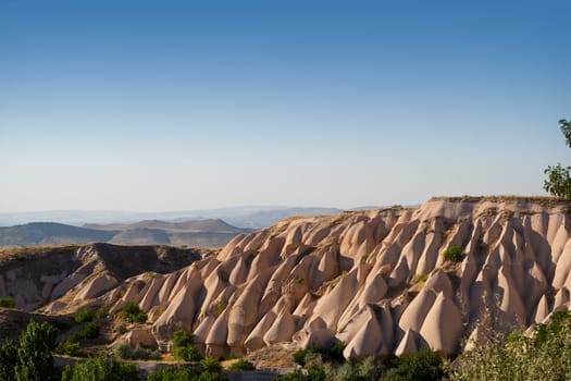 beautiful sunset landscape with typical geological soft rock formations pattern in Cappadocia plateau Turkey