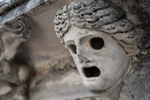 closeup perspective view of stone carved caryatid female figure on postament of ancient Greek temple