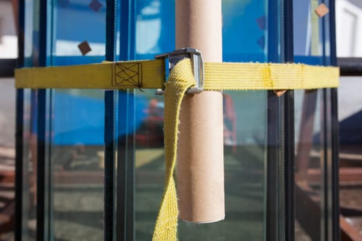 Some glass windows with straps and protected with cardboard tube. Glaziers service concept