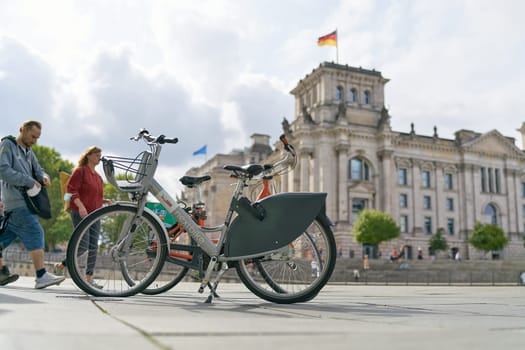 Bicycle of the public bicycle rental system of the city of Berlin Nextbike in the government district. In the background the Reichstag.