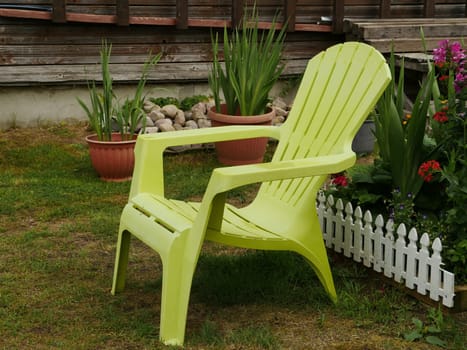 empty patio chairs in the back yard in the garden on green lawn grass, relax concept