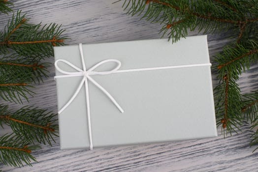 A gift parcel with christmas decoration, branch of fir, presents for the holiday, empty copy space