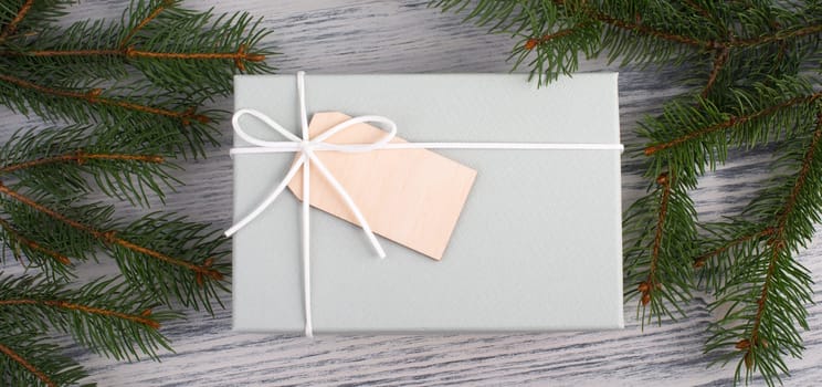 A gift parcel with christmas decoration, branch of fir, presents for the holiday, empty copy space