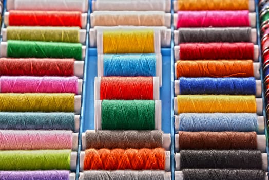 Composition with tailor threads in a box.