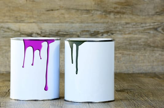 two cans of paint on a wooden table
