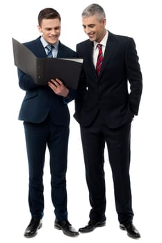 Full length of business people reviewing reports
