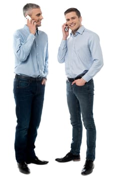 Happy young men communicate via cell phone