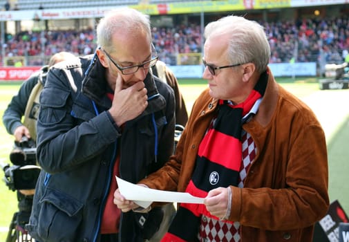 President / Praesident Fritz Keller (Freiburg) studies the line-ups with SWR reporter Stephan Basters - . 14/15 Bundesliga
