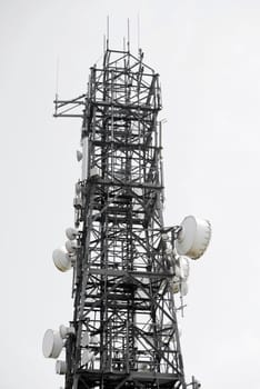 communications tower against a white sky in ireland