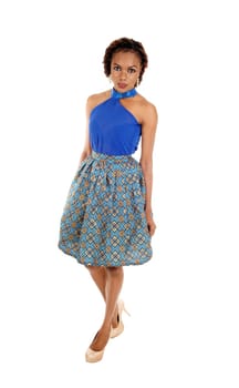 A very beautiful slim African American woman standing in a lovely skirt.and blue blouse isolated for white background..