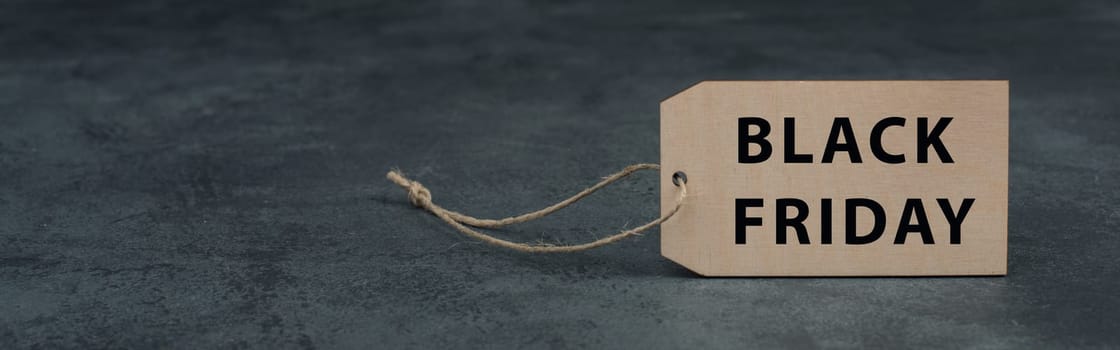Wooden label with the words black friday, dark color, copy space