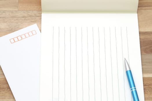 Japanese writing letter paper with ballpoint pen on wooden background