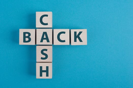The words cash back standing on wooden cubes, blue background, copy space