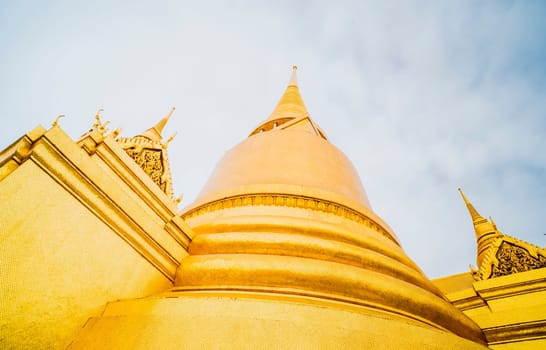 Golden Stupa of Temple of the Emerald Buddha.  Wat Phra Si Rattana Satsadaram.  Wat Phra Kaew. landmark of Bangkok Thailand with sky background.