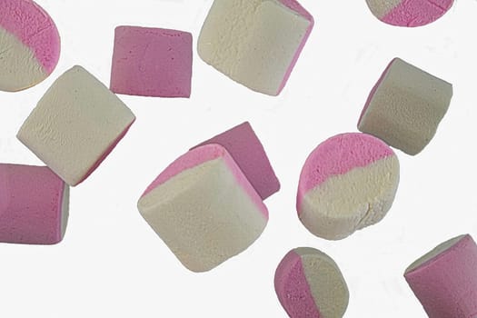 Falling marshmallow isolated on white background, clipping path, full depth of field. White and pink marshmallows falling. Marshmallow candy background.