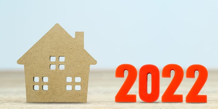 House model and number 2022 on table for finance and banking concept with copy space