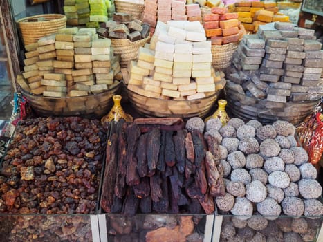 Solid fragrances and handmade perfumed soaps on display at street market.