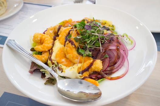 Fresh seafood salad with fried prawns. Closeup