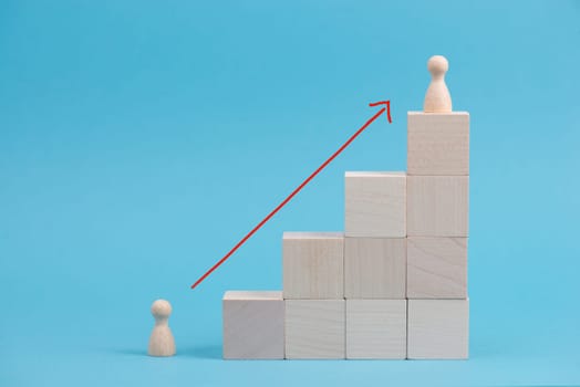 Wooden cubes building stairs, on person is standing at the bottom and the other men is standing on top, different positions