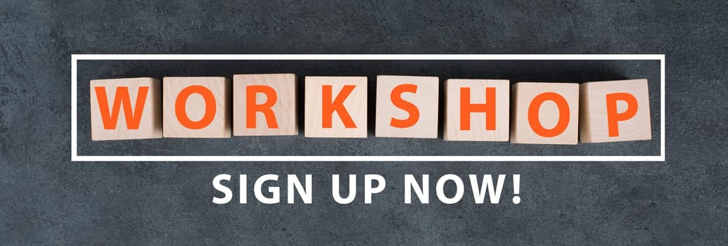 The word workshop is written on a chalkboard,hand with with chalk