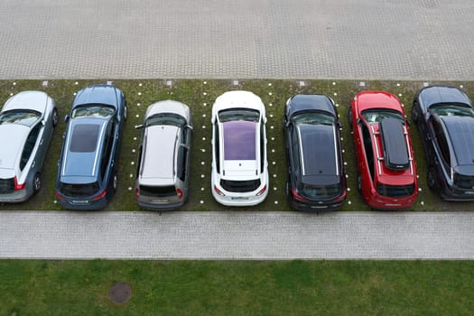 Parking lot with cars in front of a hotel in the city of Kolobrzeg in Poland from bird's eye view