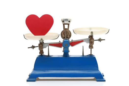 Retro roberval balance with red heart, scale on a white background