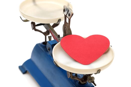 Retro roberval balance with red heart, scale on a white background