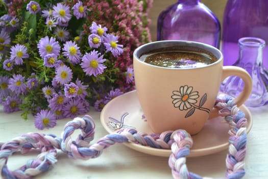 Cup of coffee with little purple violet flowers. Vintage style