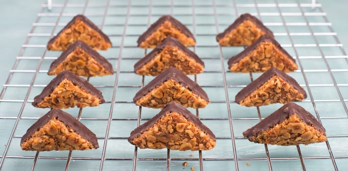 Nut corner, traditional german sweets called Nussecke, covered with chocolate, christmas baking