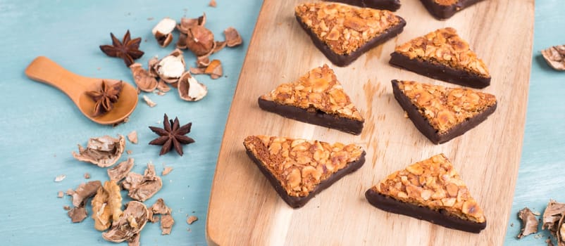 Nut corner, traditional german sweets called Nussecke, covered with chocolate, christmas baking