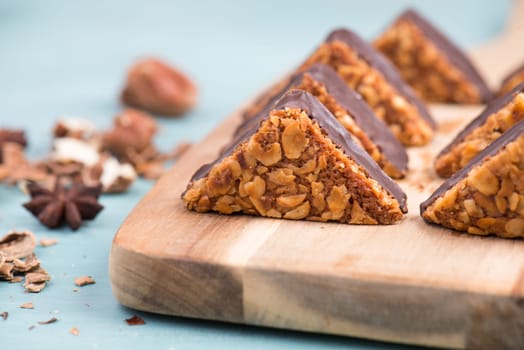 Nut corner, traditional german sweets called Nussecke, covered with chocolate, christmas baking