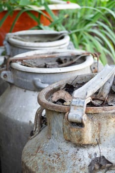Rural background with old milk cans. Vintage milk cans close up