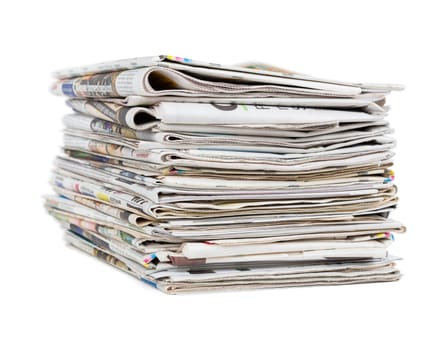 Pile of generic newspapers isolated on white background closeup shot. News and updates concept.