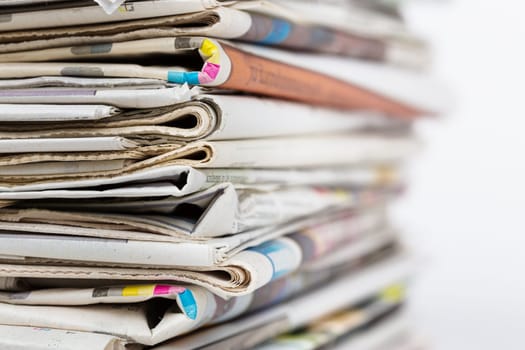 Stack of newspapers closeup shot. News and updates concept.