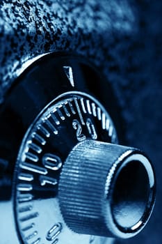 Combination lock. Dark blue colorized. Shallow DOF. Safety concept.