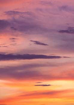 Dramatic sunset sky and clouds at twilight with bright pink, orange and yellow colors