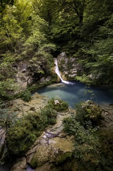 Detail of a waterfall in an ancient forest, nature