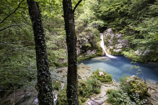 Detail of a waterfall in an ancient forest, nature