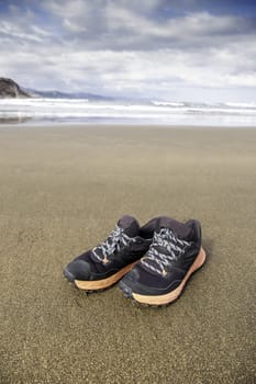 Detail of walking shoes on a beach in summer, vacation