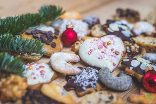 Homemade Christmas cookies, powdered sugar and Christmas bauble on a rustic wooden table