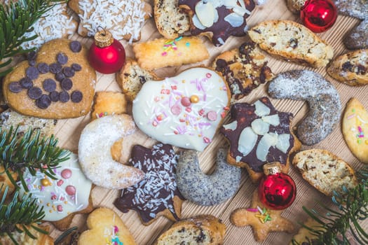 Homemade Christmas cookies, powdered sugar and Christmas bauble on a rustic wooden table