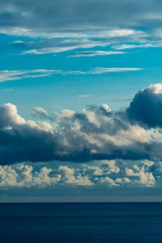 Panoramic view of bright blue sea, blue sky with fluffy white clouds