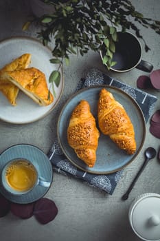 Breakfast - cup of coffee, croissants and curd cheese turnover.