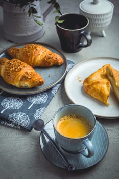 Breakfast - cup of coffee, croissants and curd cheese turnover.