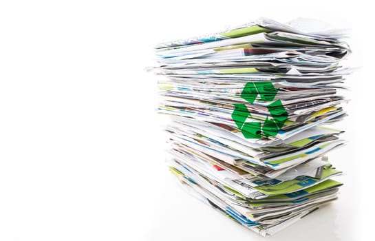 Stack of waste paper, old magazines, newspapers and leaflets for recycling isolated on white