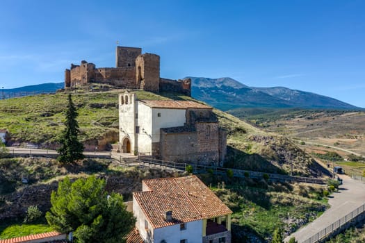 Church of the Virgin of the Cave in Trasmoz, Tarazona region, Zaragoza province, Spain. In the background the castle
