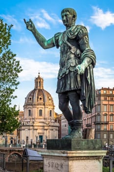 ITALY, ROME - CIRCA AUGUST 2020: Statue of Caesar Emperor, made of bronze. Natural sunrise light. Ancient  role model of Leadeship and Authority .